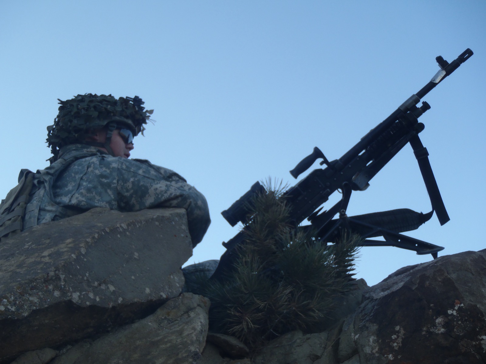 Soldier on an overwatch position scanning the horizon